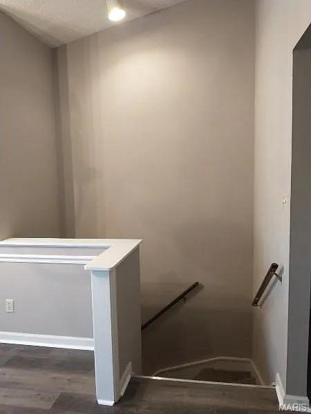 1446 Bluebird Ter, Saint Louis, MO 63144 - stairway featuring wood finished floors and baseboards
