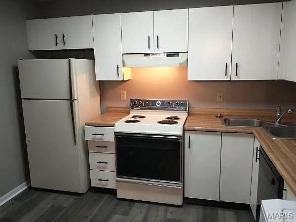 1446 Bluebird Ter, Saint Louis, MO 63144 - kitchen featuring white appliances, range hood, white cabinets, and dark wood-type flooring