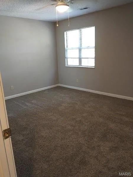1446 Bluebird Ter, Saint Louis, MO 63144 - unfurnished room featuring a ceiling fan and dark colored carpet