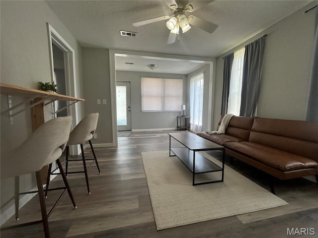 239 N Center St, Sullivan, MO 63080 - living room with a ceiling fan, a textured ceiling, and wood finished floors