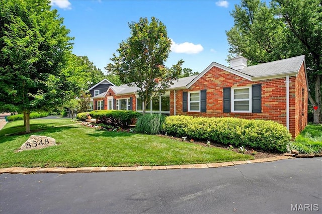 8548 Big Bend Blvd, Webster Groves, MO 63119 - view of front of home with brick siding, a front yard, and a chimney