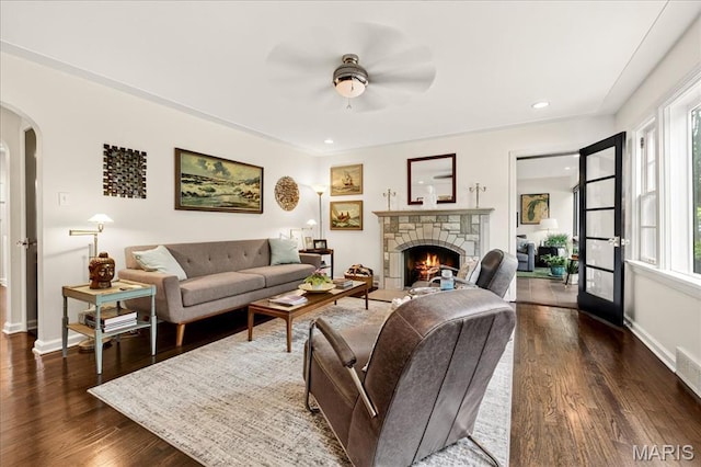 8548 Big Bend Blvd, Webster Groves, MO 63119 - living room with arched walkways, dark wood-type flooring, a fireplace, ceiling fan, and recessed lighting