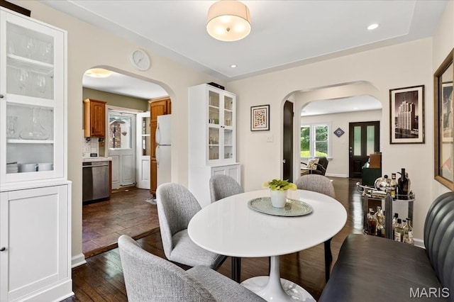 8548 Big Bend Blvd, Webster Groves, MO 63119 - dining area featuring arched walkways, dark wood-style flooring, and recessed lighting