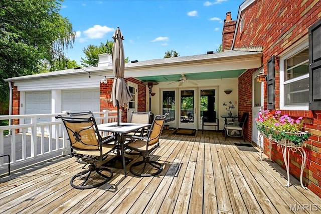 8548 Big Bend Blvd, Webster Groves, MO 63119 - wooden deck with a ceiling fan, outdoor dining area, and an attached garage