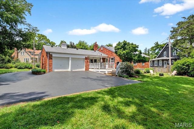 8548 Big Bend Blvd, Webster Groves, MO 63119 - view of front of house with a garage, brick siding, asphalt driveway, a front yard, and a chimney