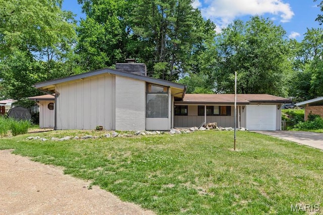 12 Country Ln, Florissant, MO 63033 - mid-century modern home featuring board and batten siding, a garage, a chimney, a front lawn, and driveway
