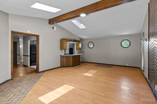 12 Country Ln, Florissant, MO 63033 - unfurnished living room with a skylight and light wood-style flooring