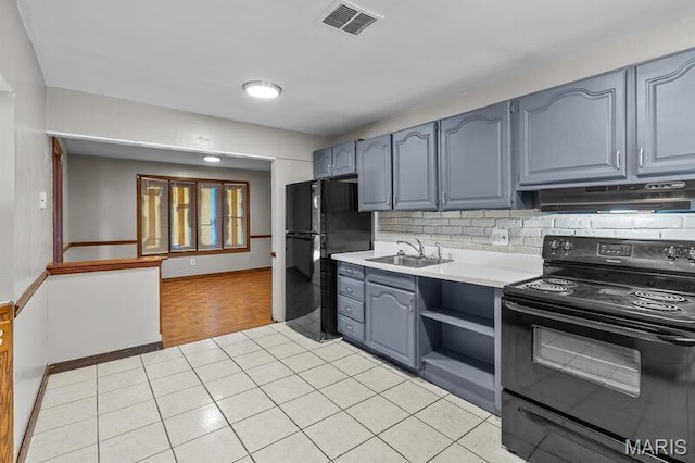 12 Country Ln, Florissant, MO 63033 - kitchen featuring black appliances, under cabinet range hood, gray cabinets, light countertops, and backsplash