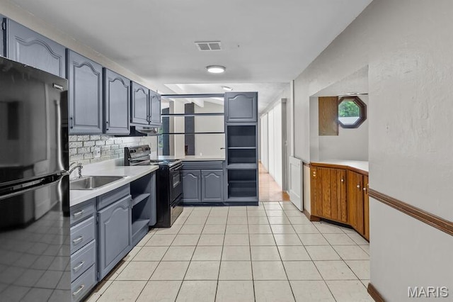 12 Country Ln, Florissant, MO 63033 - kitchen featuring freestanding refrigerator, black electric range oven, gray cabinetry, light countertops, and backsplash