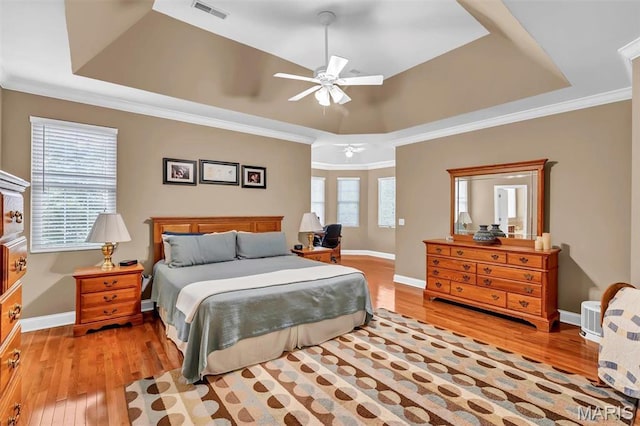 1011 Hawks Landing Dr, Lake St Louis, MO 63367 - bedroom featuring a tray ceiling, wood finished floors, ornamental molding, and a ceiling fan