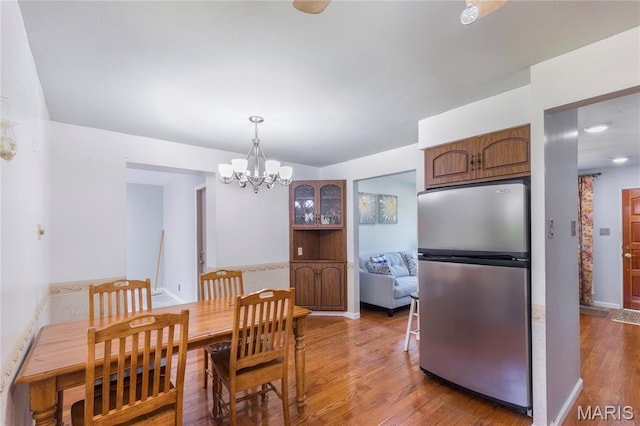 7373 Marwinette Ave, Saint Louis, MO 63116 - dining area featuring wood finished floors and a chandelier