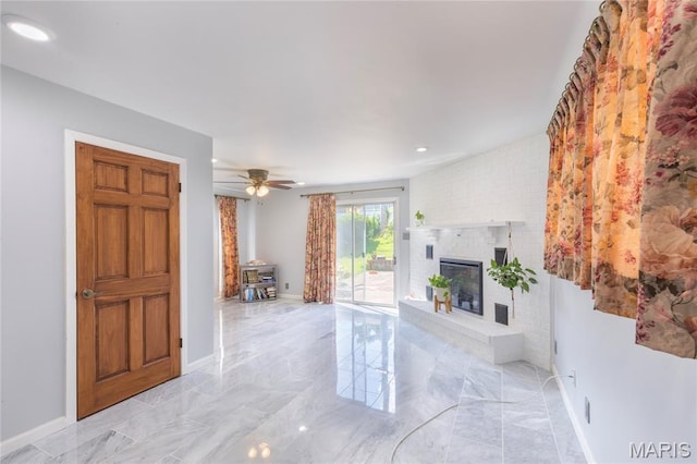 7373 Marwinette Ave, Saint Louis, MO 63116 - unfurnished living room with light marble finish flooring, a fireplace, a ceiling fan, a wood stove, and recessed lighting