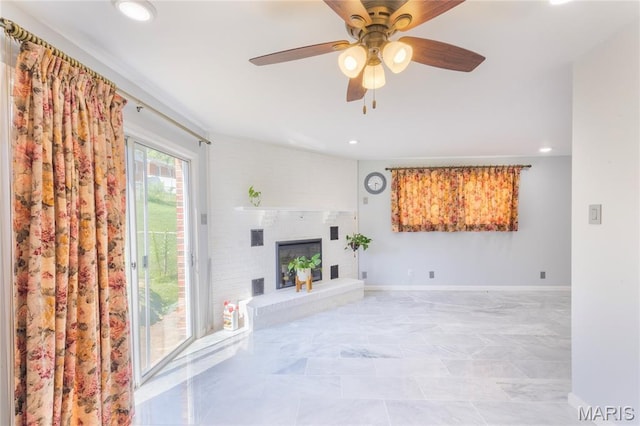 7373 Marwinette Ave, Saint Louis, MO 63116 - unfurnished living room featuring a ceiling fan, recessed lighting, and a fireplace with raised hearth
