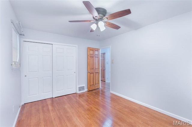 7373 Marwinette Ave, Saint Louis, MO 63116 - unfurnished bedroom featuring light wood-style floors, a closet, and ceiling fan