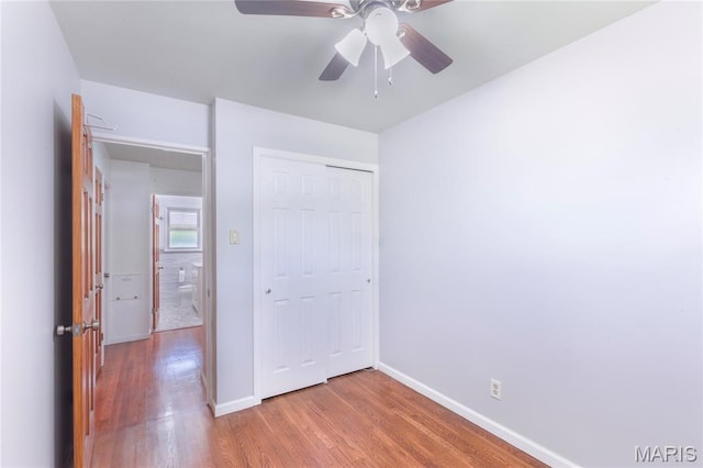 7373 Marwinette Ave, Saint Louis, MO 63116 - unfurnished bedroom featuring wood finished floors, a closet, and a ceiling fan