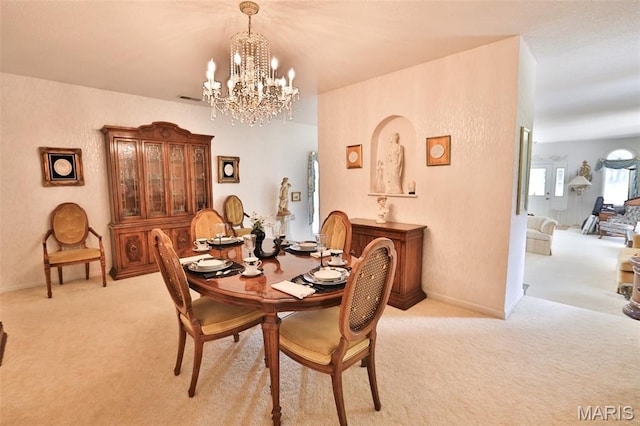613 N W St, Raymond, IL 62560 - dining area with light colored carpet and a chandelier