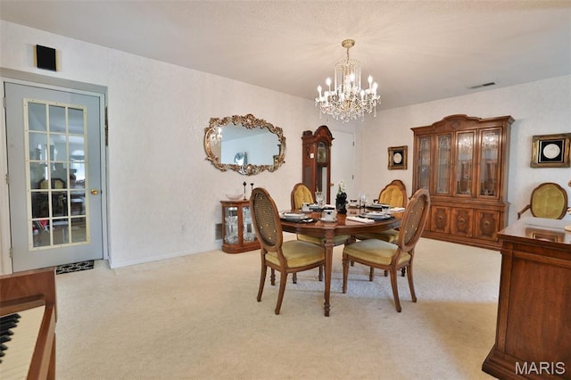 613 N W St, Raymond, IL 62560 - carpeted dining space with a chandelier and baseboards