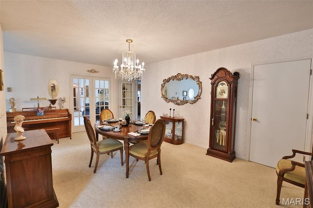 613 N W St, Raymond, IL 62560 - dining space featuring light carpet, a chandelier, a textured ceiling, and french doors