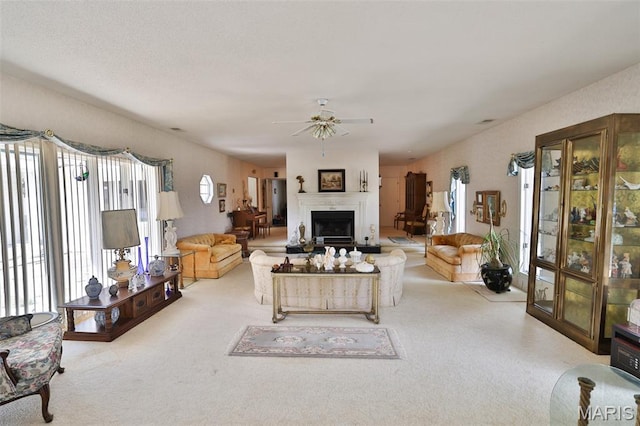 613 N W St, Raymond, IL 62560 - carpeted living room featuring ceiling fan and a fireplace