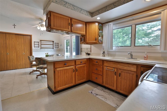 613 N W St, Raymond, IL 62560 - kitchen with a peninsula, a ceiling fan, light countertops, brown cabinets, and recessed lighting