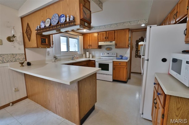 613 N W St, Raymond, IL 62560 - kitchen featuring white appliances, a peninsula, under cabinet range hood, and brown cabinets
