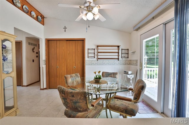613 N W St, Raymond, IL 62560 - dining room featuring lofted ceiling, a textured ceiling, healthy amount of natural light, a ceiling fan, and light tile patterned floors