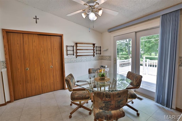 613 N W St, Raymond, IL 62560 - dining area featuring a textured ceiling, wainscoting, vaulted ceiling, a ceiling fan, and tile patterned flooring