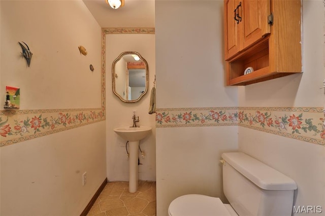 613 N W St, Raymond, IL 62560 - bathroom featuring toilet and a wainscoted wall