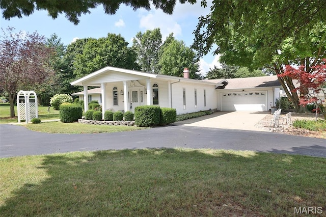 613 N W St, Raymond, IL 62560 - view of front facade featuring a garage, concrete driveway, a front yard, and a chimney