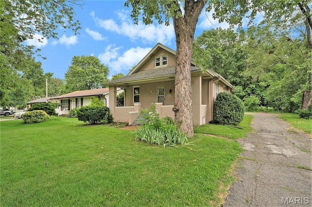 11714 Larimore Rd, Saint Louis, MO 63138 - view of front of house with a front yard, brick siding, and asphalt driveway