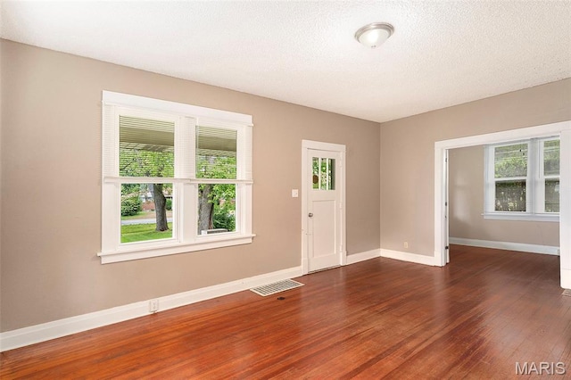 11714 Larimore Rd, Saint Louis, MO 63138 - foyer entrance featuring healthy amount of natural light, wood finished floors, and a textured ceiling