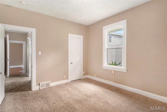 11714 Larimore Rd, Saint Louis, MO 63138 - unfurnished bedroom featuring carpet flooring and a textured ceiling
