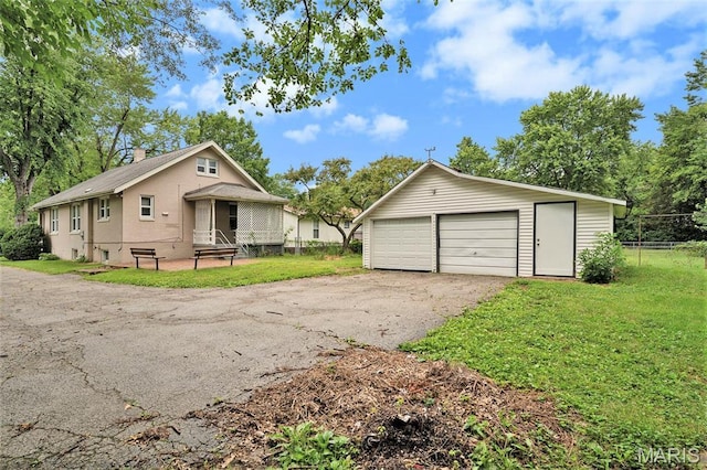 11714 Larimore Rd, Saint Louis, MO 63138 - view of front facade featuring an outbuilding, a detached garage, and a chimney