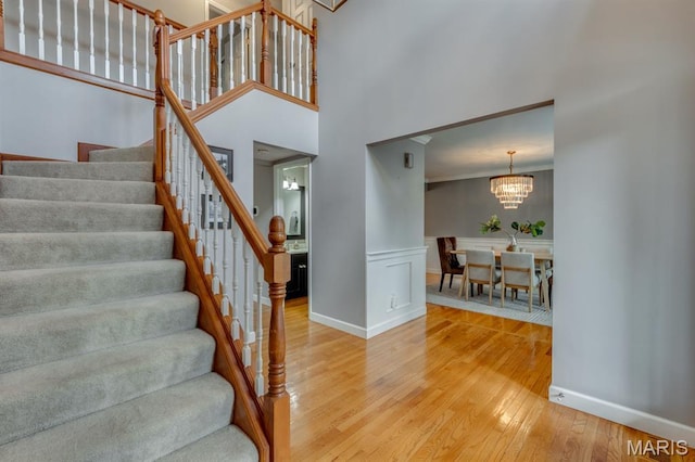 13153 Barrett Meadows Dr, Ballwin, MO 63021 - stairs featuring hardwood / wood-style floors, a chandelier, and a high ceiling