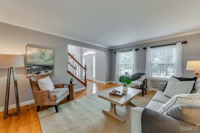 13153 Barrett Meadows Dr, Ballwin, MO 63021 - living room with ornamental molding, light wood finished floors, and stairway