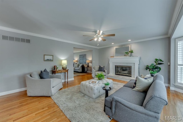 13153 Barrett Meadows Dr, Ballwin, MO 63021 - living room featuring a fireplace, a ceiling fan, light wood-style floors, crown molding, and recessed lighting