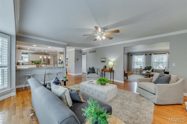 13153 Barrett Meadows Dr, Ballwin, MO 63021 - living area with a ceiling fan, ornamental molding, and light wood-style floors