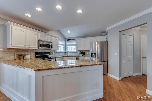 13153 Barrett Meadows Dr, Ballwin, MO 63021 - kitchen with stainless steel appliances, a peninsula, light stone counters, light wood-type flooring, and recessed lighting