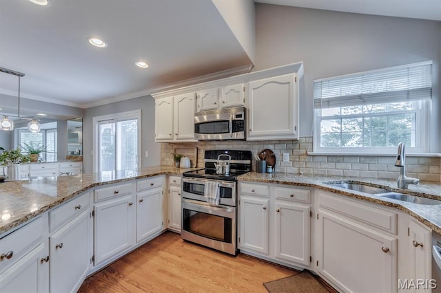 13153 Barrett Meadows Dr, Ballwin, MO 63021 - kitchen with stainless steel appliances, ornamental molding, healthy amount of natural light, white cabinetry, and tasteful backsplash
