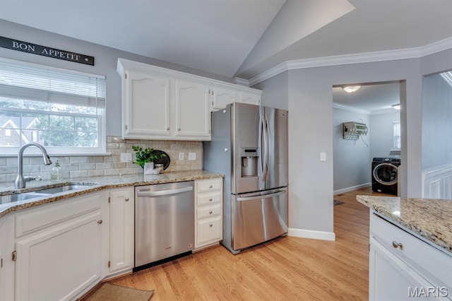 13153 Barrett Meadows Dr, Ballwin, MO 63021 - kitchen with stainless steel appliances, washer / clothes dryer, ornamental molding, decorative backsplash, and white cabinets