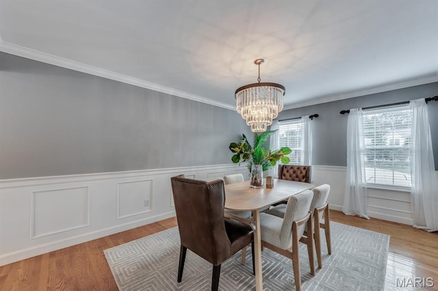 13153 Barrett Meadows Dr, Ballwin, MO 63021 - dining space with a chandelier, a wainscoted wall, light wood-style floors, and ornamental molding