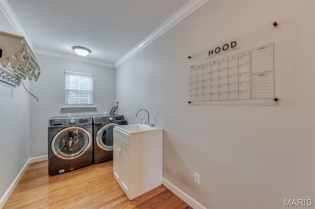 13153 Barrett Meadows Dr, Ballwin, MO 63021 - washroom featuring separate washer and dryer, crown molding, cabinet space, and light wood-type flooring