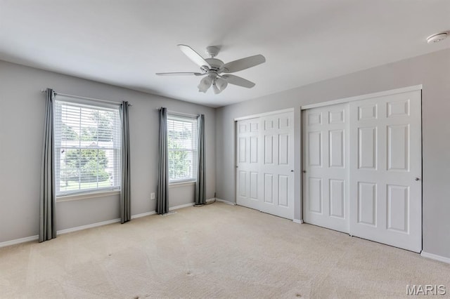 13153 Barrett Meadows Dr, Ballwin, MO 63021 - unfurnished bedroom featuring multiple closets, carpet flooring, and a ceiling fan