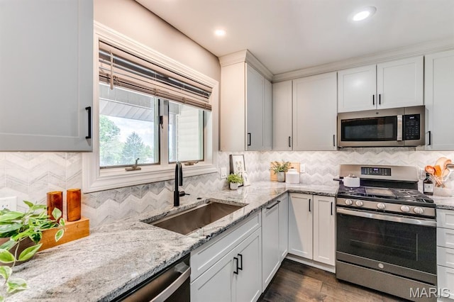 3534 Carriage Run Dr, Saint Charles, MO 63303 - kitchen featuring stainless steel appliances, light stone countertops, decorative backsplash, white cabinets, and recessed lighting