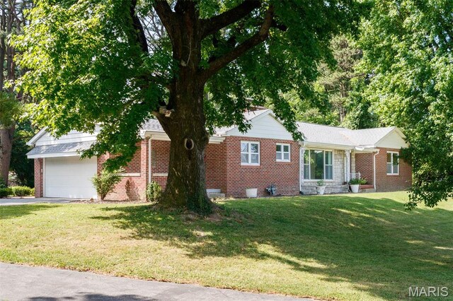 110 N 74th St, Belleville, IL 62223 - view of front of home featuring brick siding, a garage, driveway, and a front lawn