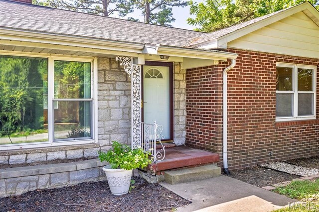 110 N 74th St, Belleville, IL 62223 - doorway to property with stone siding, a shingled roof, and brick siding