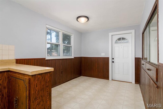 110 N 74th St, Belleville, IL 62223 - entryway with wainscoting, wooden walls, and light flooring