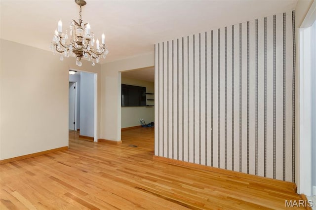 110 N 74th St, Belleville, IL 62223 - empty room featuring a chandelier and light wood-type flooring