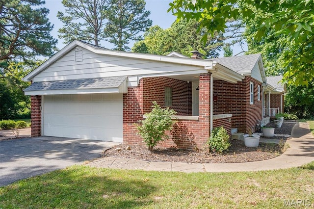 110 N 74th St, Belleville, IL 62223 - view of front of house with an attached garage, brick siding, roof with shingles, and driveway