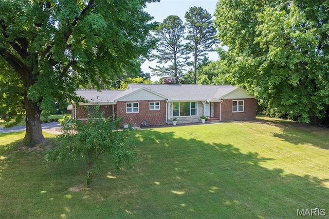 110 N 74th St, Belleville, IL 62223 - ranch-style home featuring brick siding, a chimney, and a front yard